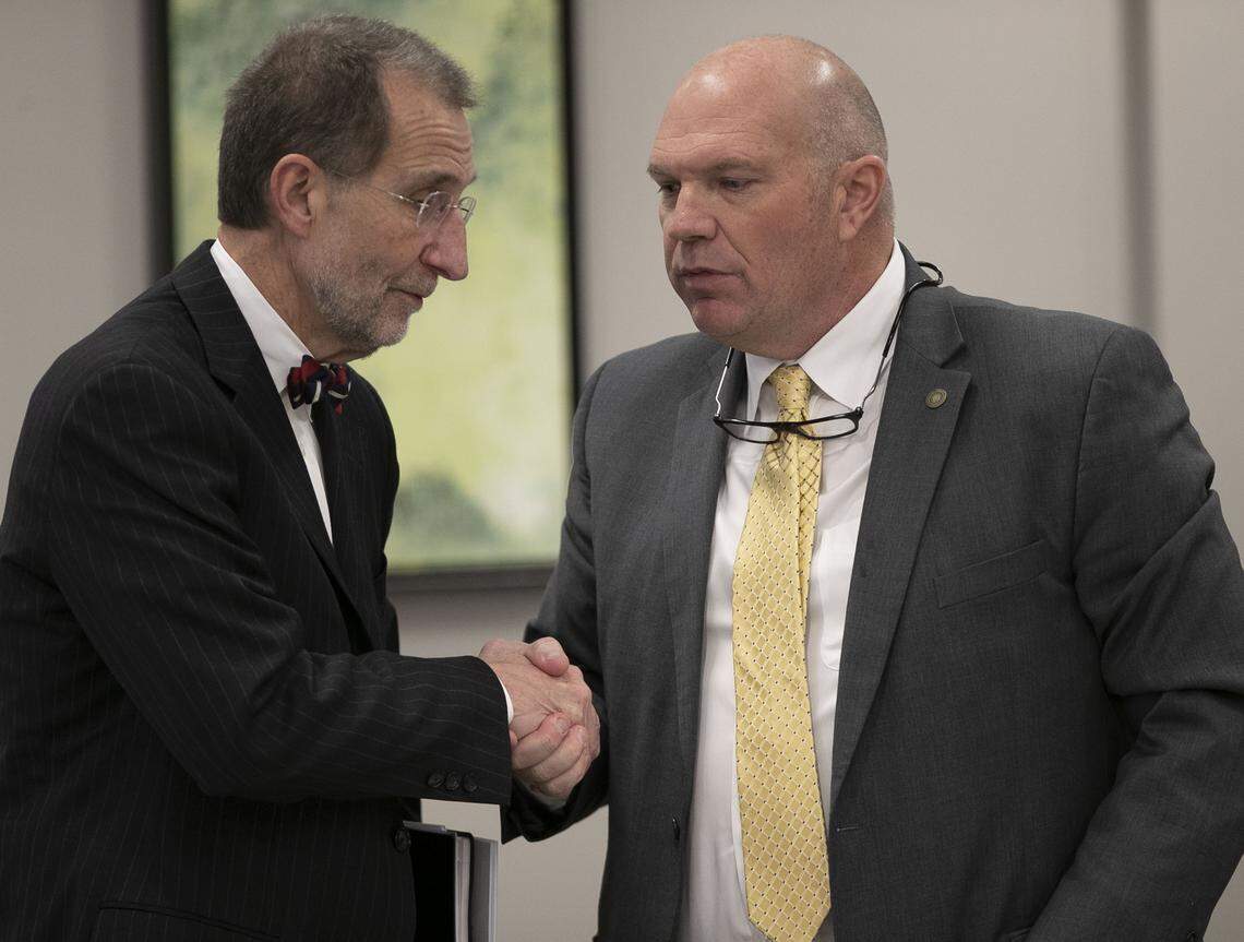 UNC Board of Governors chairman Harry Smith, right, shakes hands with UNC Interim President Dr. Bill Roper following the Board of Governors meeting on Friday, January 25, 2019 in Chapel Hill, N.C.