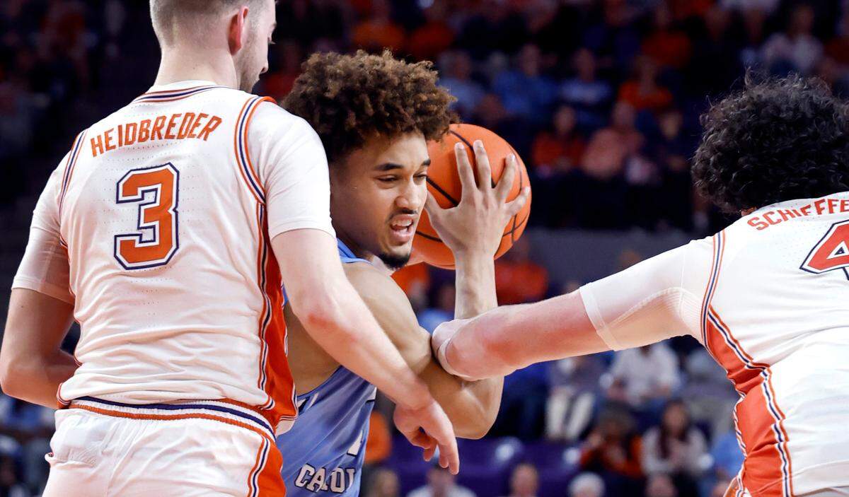 Clemson’s Jake Heidbreder (3) and Ian Schieffelin (4) pressure North Carolina’s Seth Trimble (7) during the second half of Clemson’s 85-65 victory over UNC at Littlejohn Coliseum in Clemson, S.C., Monday, Feb. 10, 2025.
