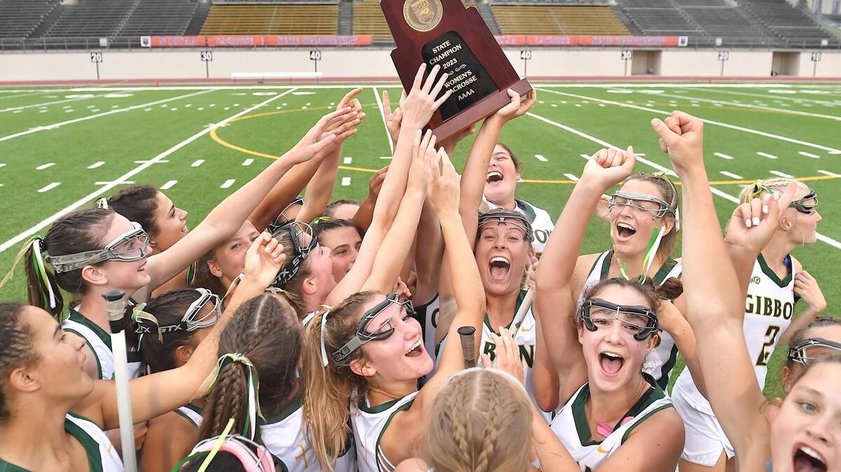 The Cardinal Gibbons Crusaders celebrate with the State Championship trophy after defeating Charlotte Catholic 15-11. The Charlotte Catholic Cougars and the Cardinal Gibbons Crusaders met in the NCHSAA 4A Girls Lacrosse Final in Durham , NC on May 19, 2023.