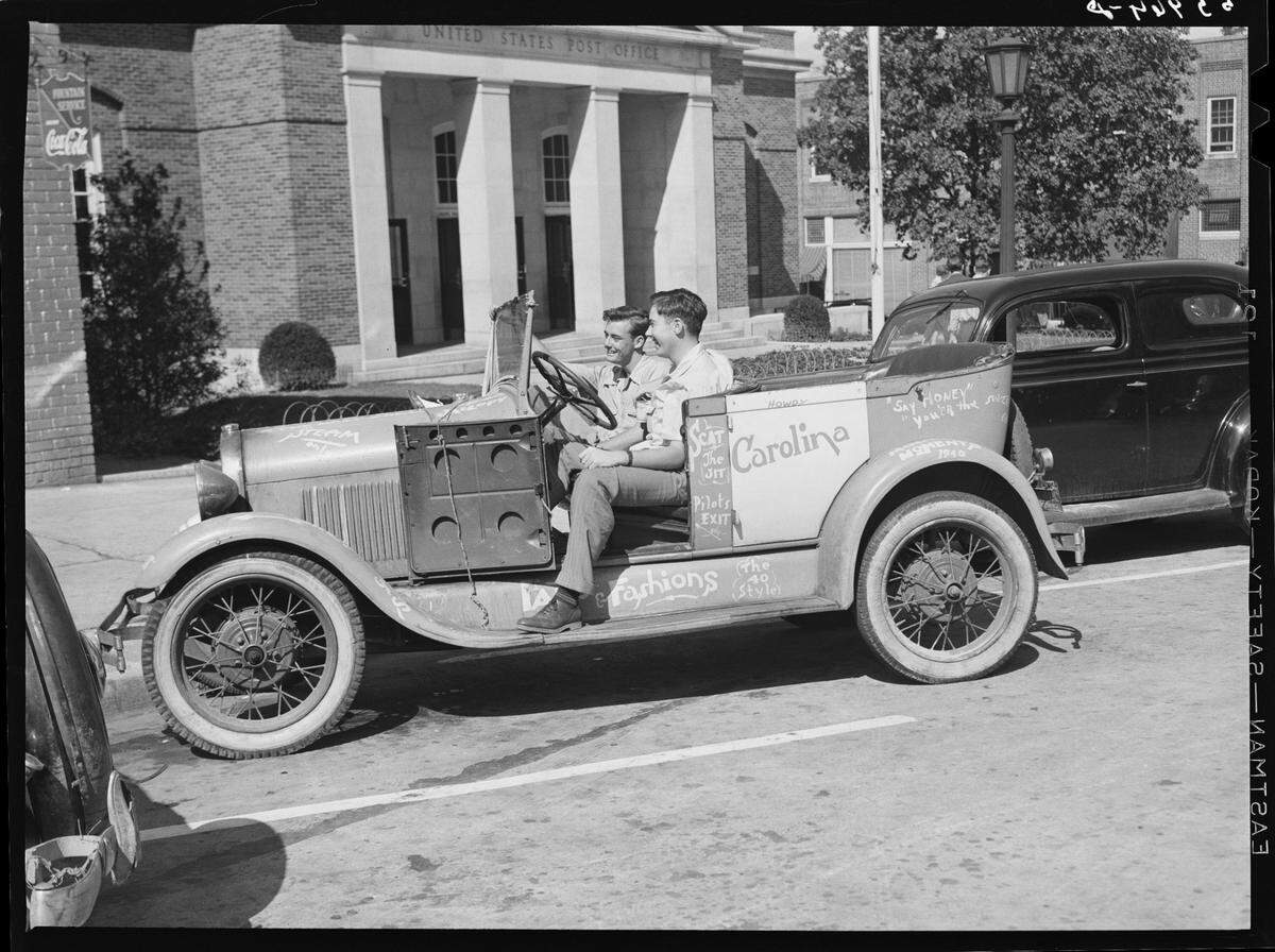 In this 1939 photograph, University of North Carolina students sit in their car in front of the post office on Franklin Street in Chapel Hill, North Carolina.