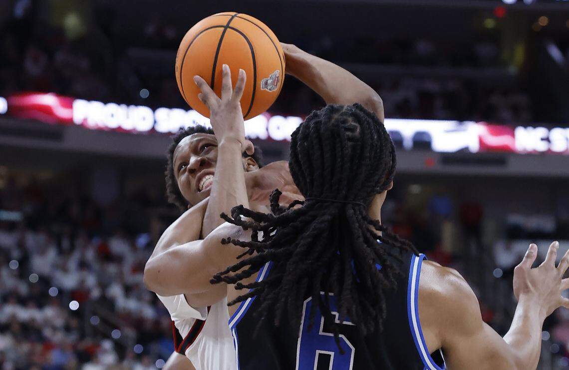 NC State's Quadir Copeland (11) is fouled by Duke’s Maliq Brown (6) during the first half of Duke’s game against N.C. State at the Lenovo Center in Raleigh, N.C., Monday, March 2, 2026.