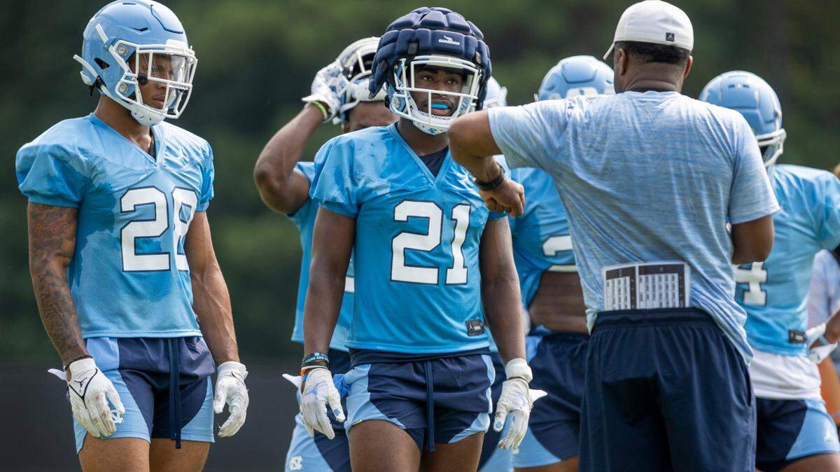 North Carolina running backs coach Larry Porter works with Elijah Green (21) during their first day of practice on Wednesday, August 2, 2023 in Chapel Hill, N.C.
