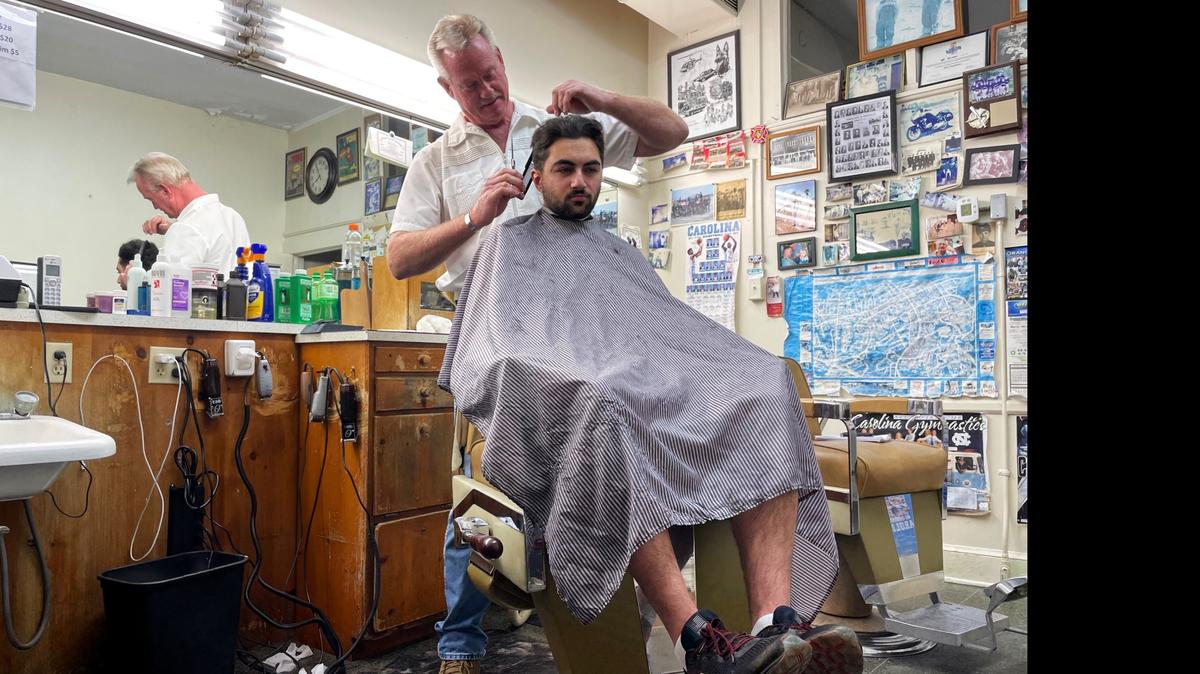 Owner Russ Sturdivant gives James Peres-da-Silva a cut and a shave as he winds down the work day at Friendly Barber Shop on East Main Street in Carrboro. Sturdivant’s father Grady Sturdivant opened the shop in 1961. The doors will close April 30.
