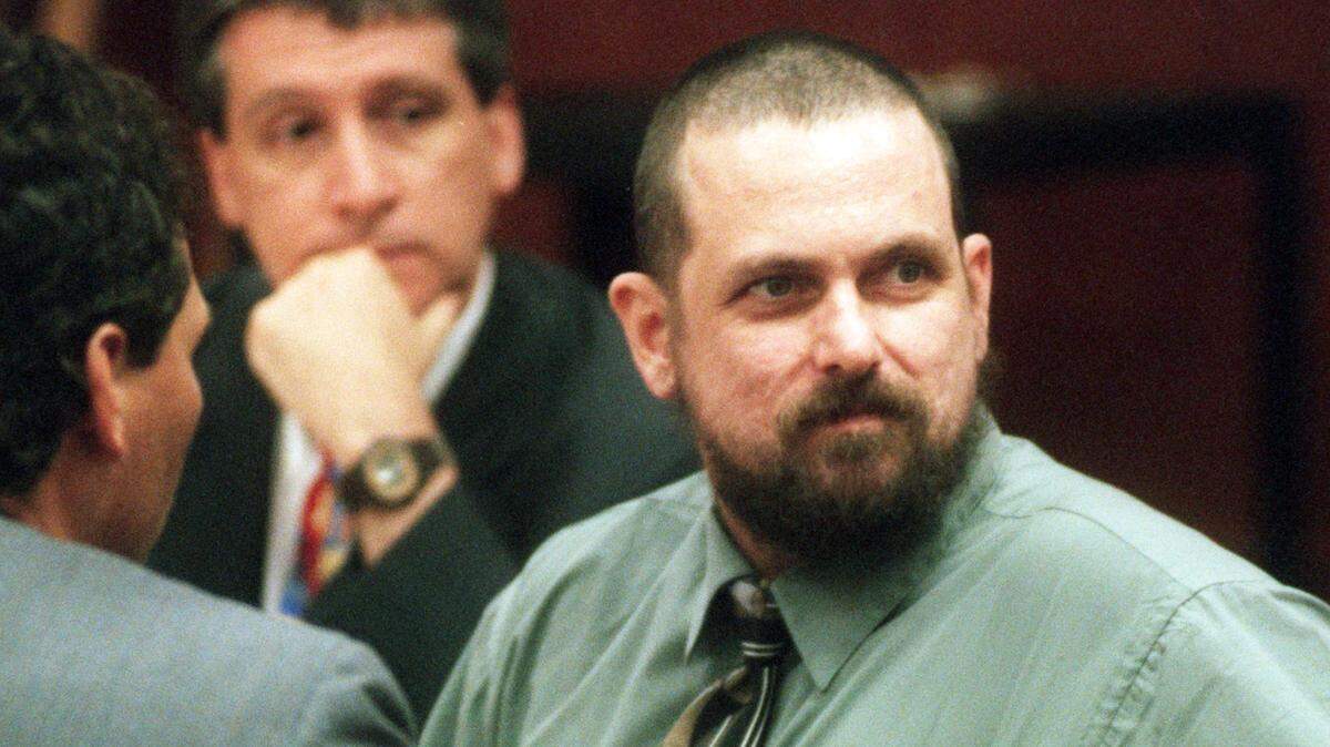 Allen Holman sits in court with lawyers Douglas Corkhill and J. Anthony Penry in 1998. Holman pleaded guilty to shooting his wife, Linda, to death at an Apex gas station. He died of natural causes on April 19, 2023, while serving on death row.