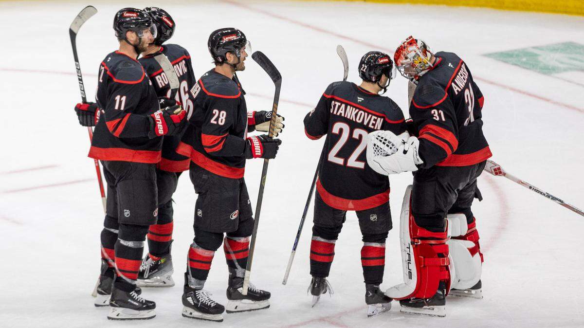 Carolina Hurricanes center Logan Stankoven (22) congratulates goalie Frederik Andersen (31) following their 4-1 victory over the New Jersey Devils on Sunday, April 20, 2025 at Lenovo Center in Raleigh, N.C. Stankoven scored two goals, and Andersen had 24 saves to secure the victory.