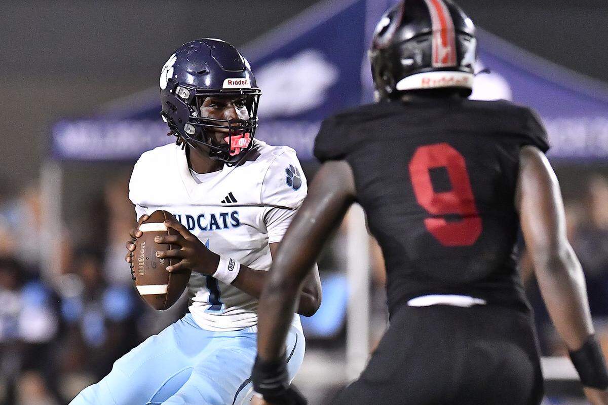 Millbrook quarterback Bryson Gray (1) looks to pass downfield against Rolesville during the second half. The Millbrook Wildcats and the Rolesville Rams met in a conference football game in Rolesville, N.C. September 26, 2025