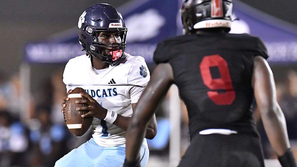 Millbrook quarterback Bryson Gray (1) looks to pass downfield against Rolesville during the second half. The Millbrook Wildcats and the Rolesville Rams met in a conference football game in Rolesville, N.C. September 26, 2025