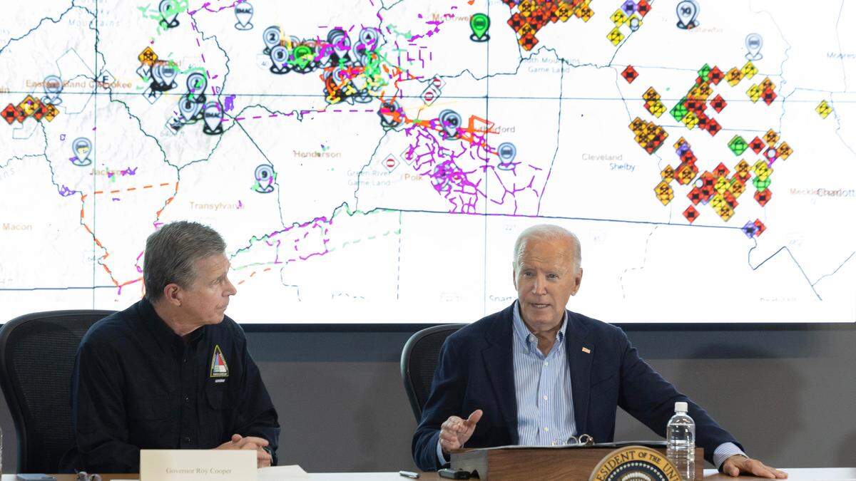 President Joe Biden speaks while getting a briefing on the response to Hurricane Helene at the N.C. Emergency Operations Center in Raleigh, N.C., Wednesday, Oct. 2, 2024. N.C. Gov. Roy Cooper sits to the left.