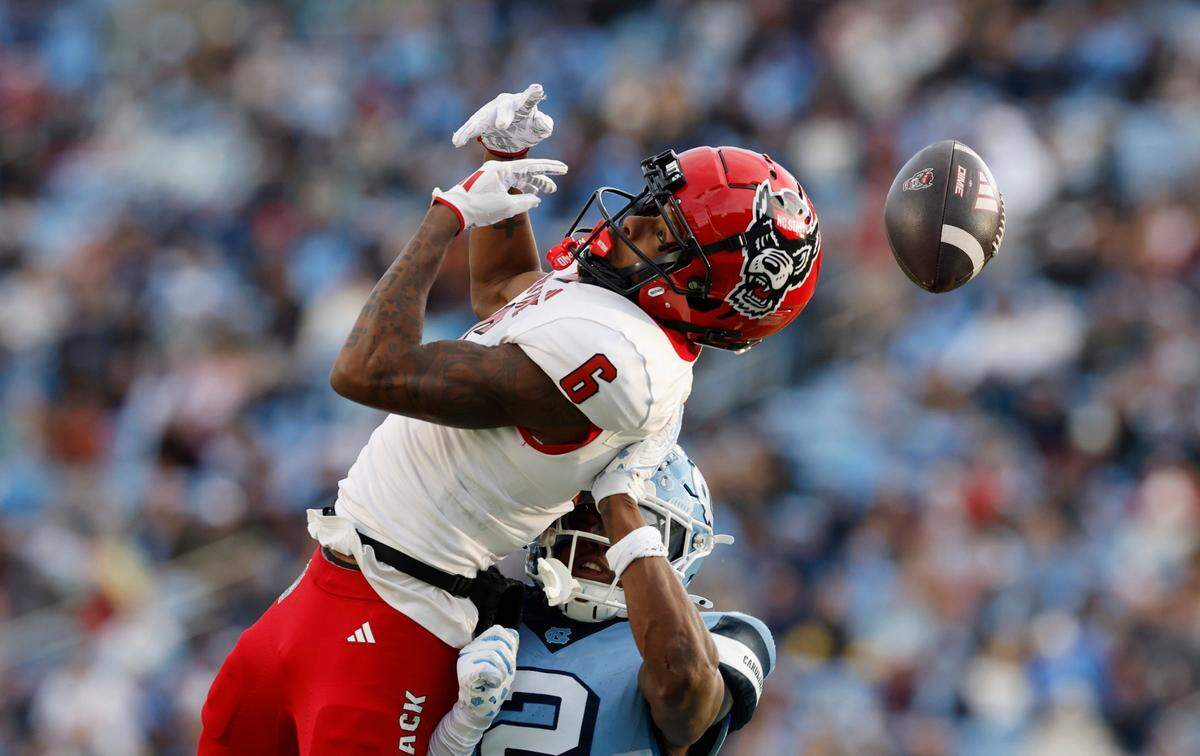 N.C. State wide receiver Wesley Grimes (6) can’t pull in the pass while defended by North Carolina defensive back Jakeen Harris (2) during the first half of N.C. State’s game against UNC at Kenan Stadium in Chapel Hill, N.C., Saturday, Nov. 30, 2024.