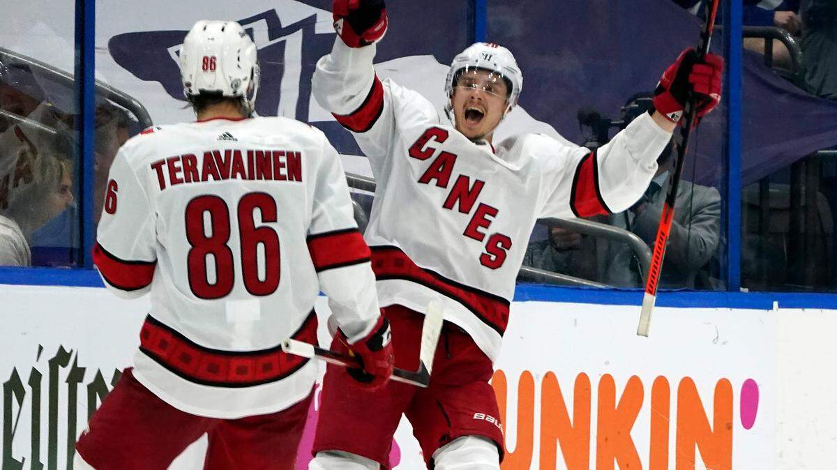 Carolina Hurricanes right wing Sebastian Aho (20) celebrates his goal against the Tampa Bay Lightning with left wing Teuvo Teravainen (86) during the second period in Game 3 of an NHL hockey Stanley Cup second-round playoff series Thursday, June 3, 2021, in Tampa, Fla. (AP Photo/Chris O’Meara)