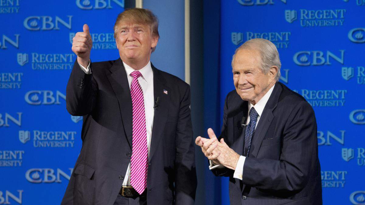 Republican presidential candidate Donald Trump, accompanied by Rev. Pat Robertson, gives a thumbs up to the crowd after speaking at Regent University in Virginia Beach, Va., Wednesday, Feb. 24, 2016.