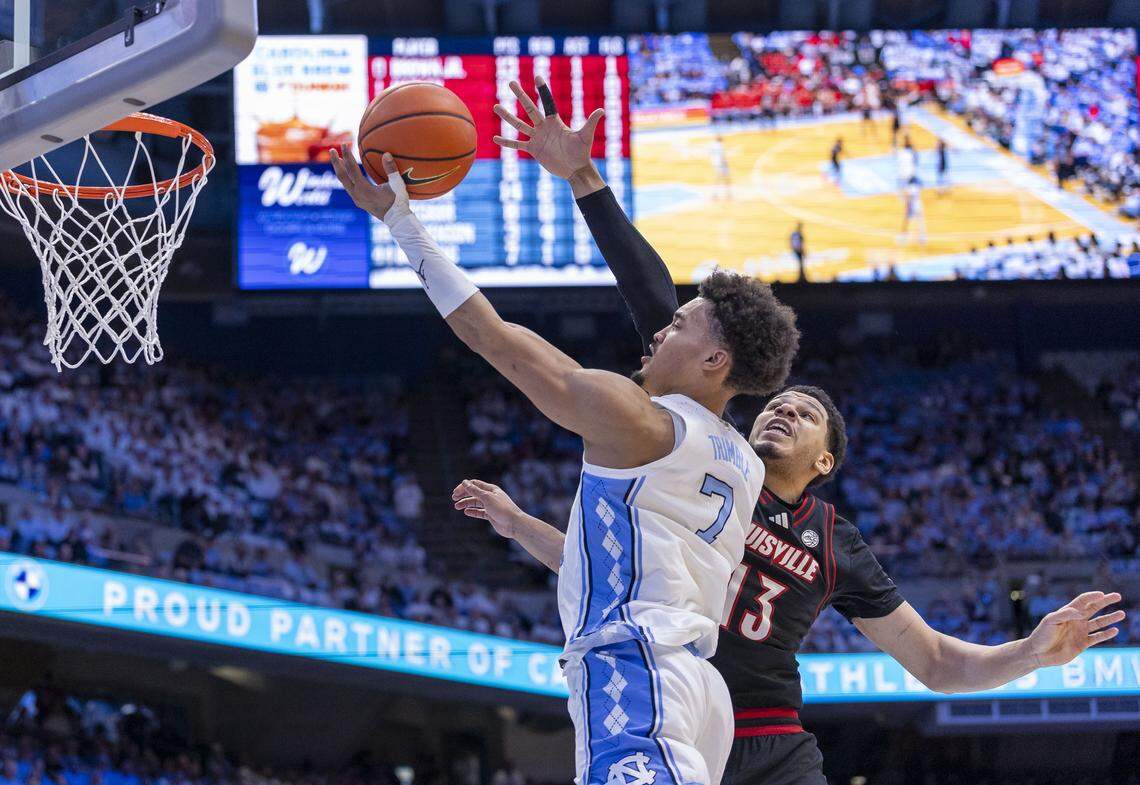 North Carolina guard Seth Trimble (7) drives to the basket against Louisville forward Sananda Fru (13) in the first half on Monday, February 23, 2026 at the Smith Center in Chapel Hill, N.C.