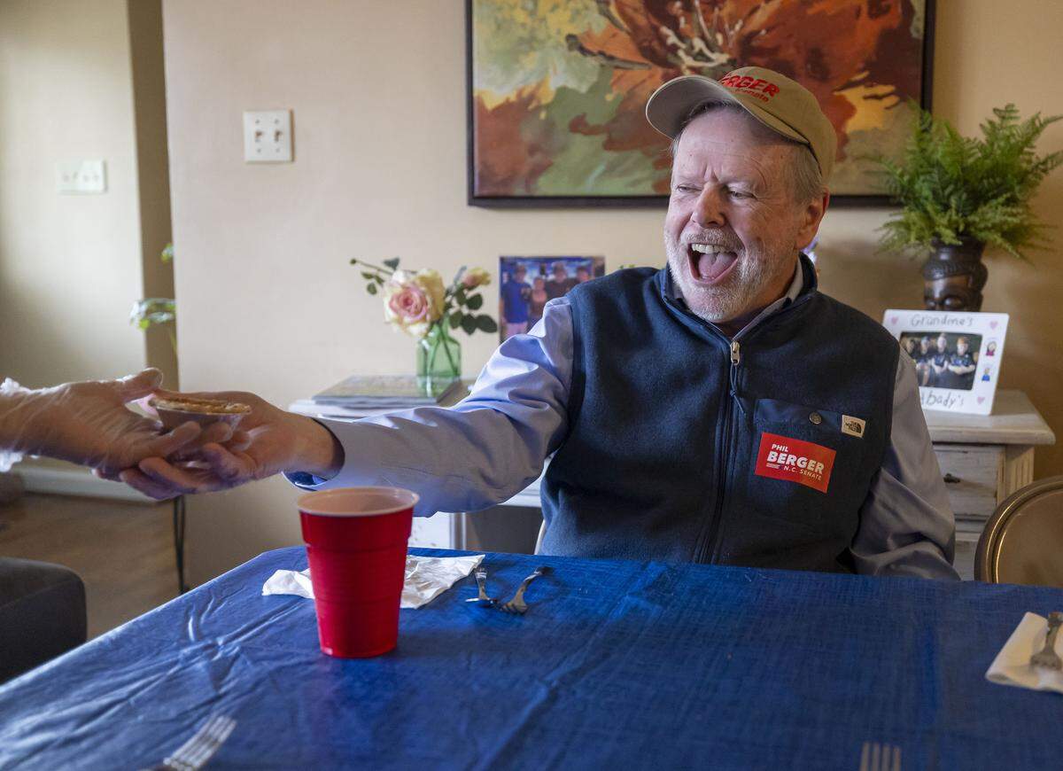 NC Senate leader Phil Berger receives a pecan pie from host Sherry Hall during lunch at her home on Tuesday, Feb. 24, 2026 in Eden, N.C. Sherry and Jonathan Hall host a group of friends including Berger at their home several times a year for a lunch of pinto beans and cornbread with all the trimmings. 
