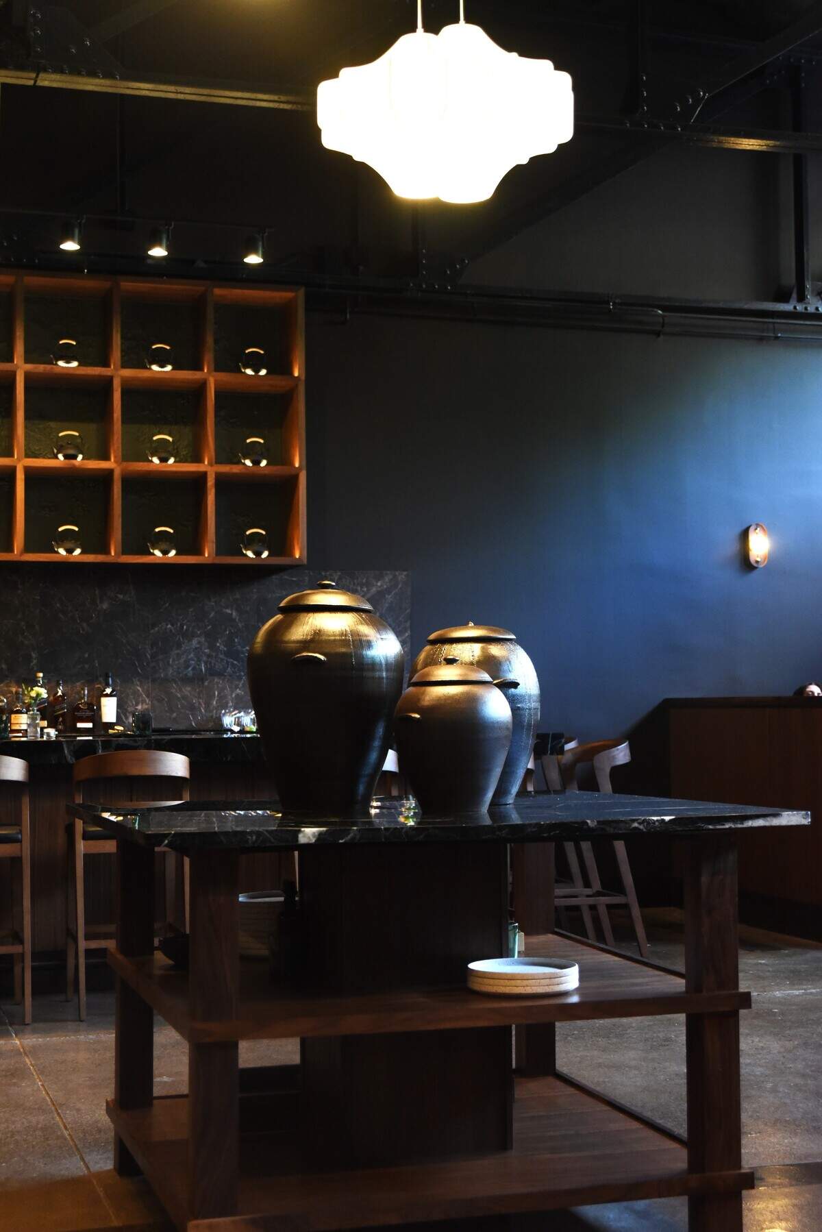 Decorative kimchi urns stand on a table in the middle of the dining room of the new M Hansik in Durham.