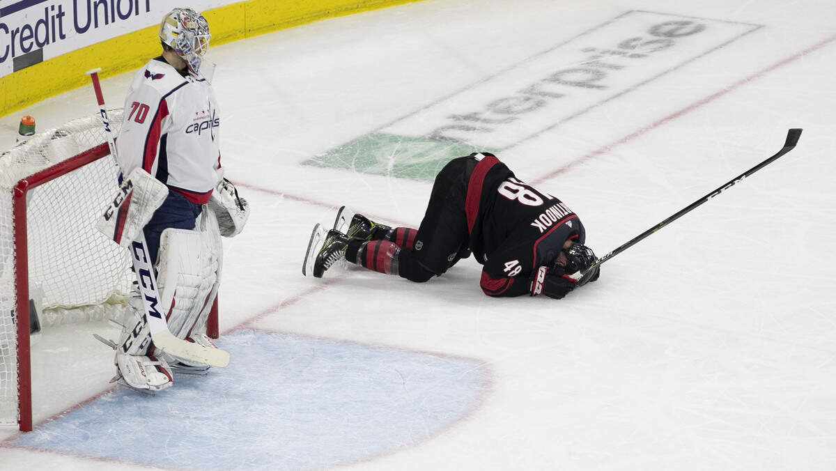 Carolina Hurricanes’ Jordan Martinook (48) goes down in front of Washington Capitals’ goalie Braden Holtby (70) after injuring himself during the first period in game four of the first round Stanley Cup series game on Thursday, April 18, 2019 at the PNC Arena in Raleigh, N.C.