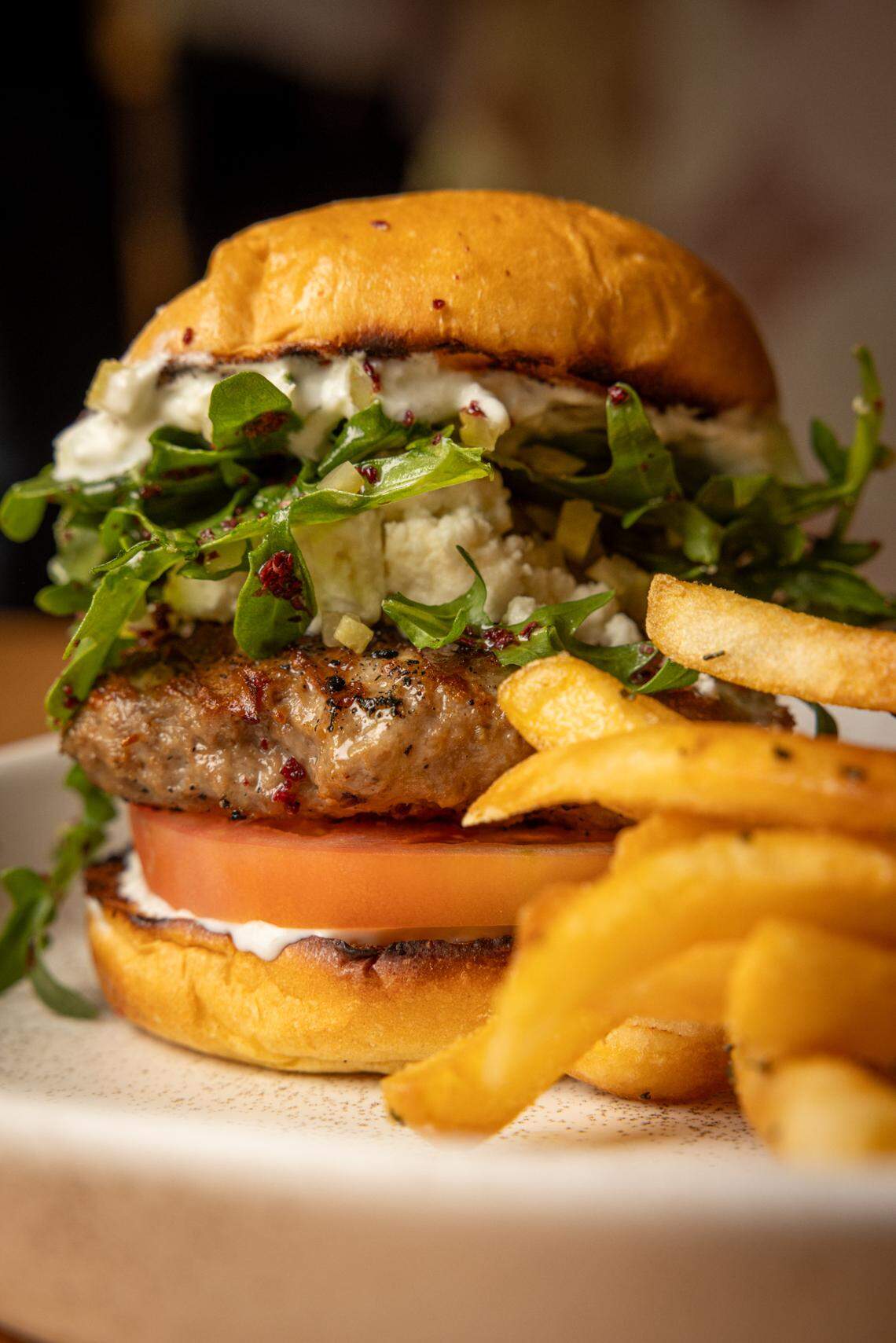 Boatman Spirits Co. in Raleigh opens as a new craft cocktail bar, distillery and Mediterranean restaurant. On the opening food menu is a lamb kofta burger.