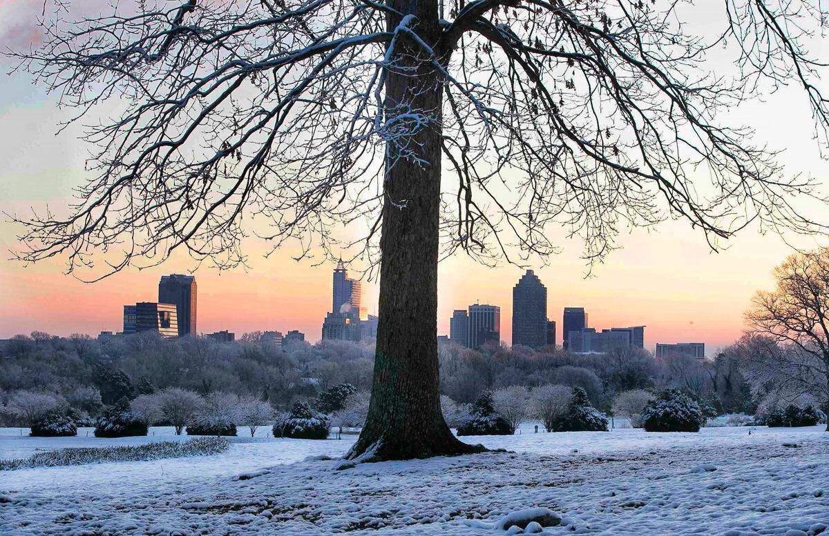 The view of the Raleigh skyline just before sunrise from Dix Park on Friday, February 22, 2020 in Raleigh, N.C., after a winter storm passed through the area overnight.