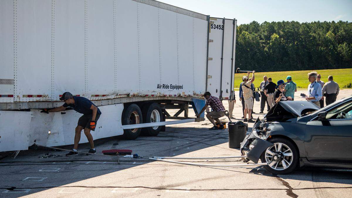 Cary engineer Aaron Kiefer assesses damage to his prototype of an underride guard after pulling a Nissan Altima at nearly 35 miles per hour into the side of a box trailer. Keifer’s system is designed to prevent deadly side underride crashes.