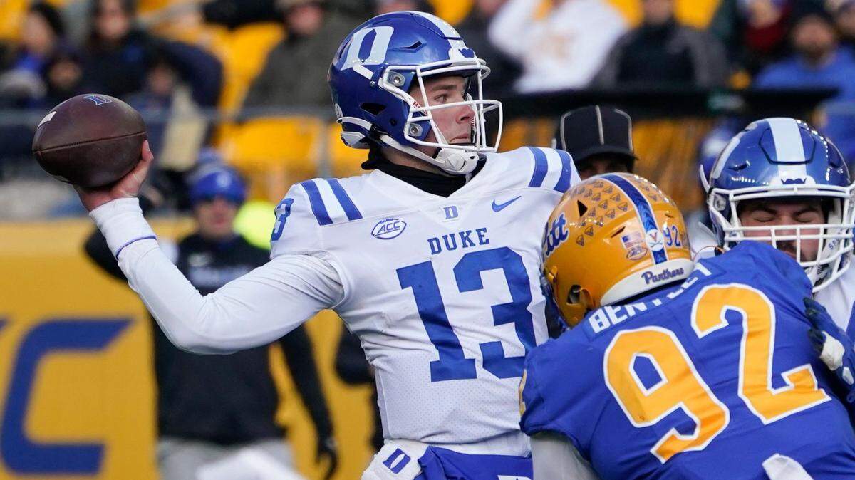 Duke quarterback Riley Leonard (13) passes as Pittsburgh defensive lineman Tyler Bentley (92) pressures during the first half of an NCAA college football game, Saturday, Nov. 19, 2022, in Pittsburgh. (AP Photo/Keith Srakocic)