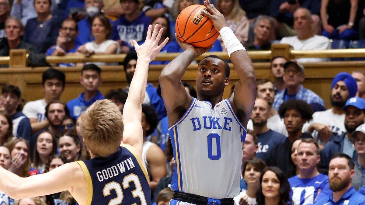 Duke’s Dariq Whitehead (0) hits a three-pointer as Notre Dame’s Dane Goodwin (23) defends during the first half of Duke’s game against Notre Dame at Cameron Indoor Stadium in Durham, N.C., Tuesday, Feb. 14, 2023.