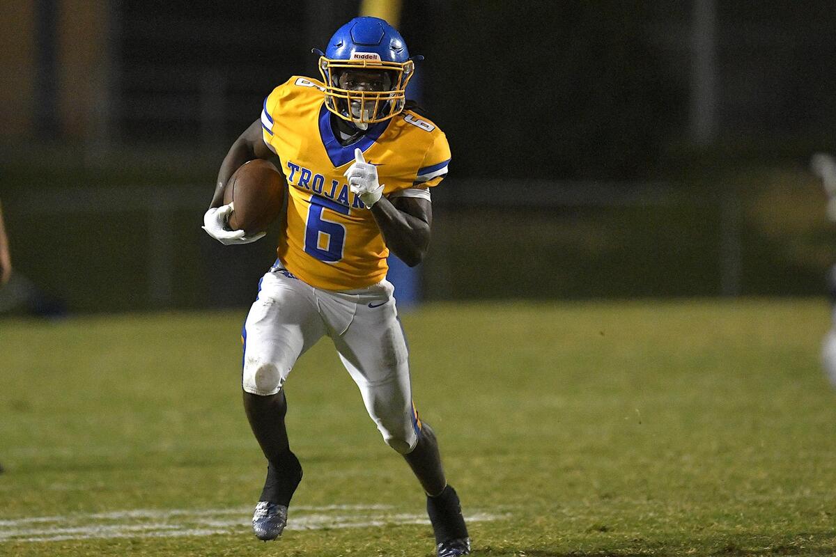 Garner’s Isaiah Dawson (6) runs for yardage during the first half against Southeast Raleigh. The Garner Trojans and the Southeast Raleigh Bulldogs met in a conference football game in Garner, N.C, on October 6, 2023