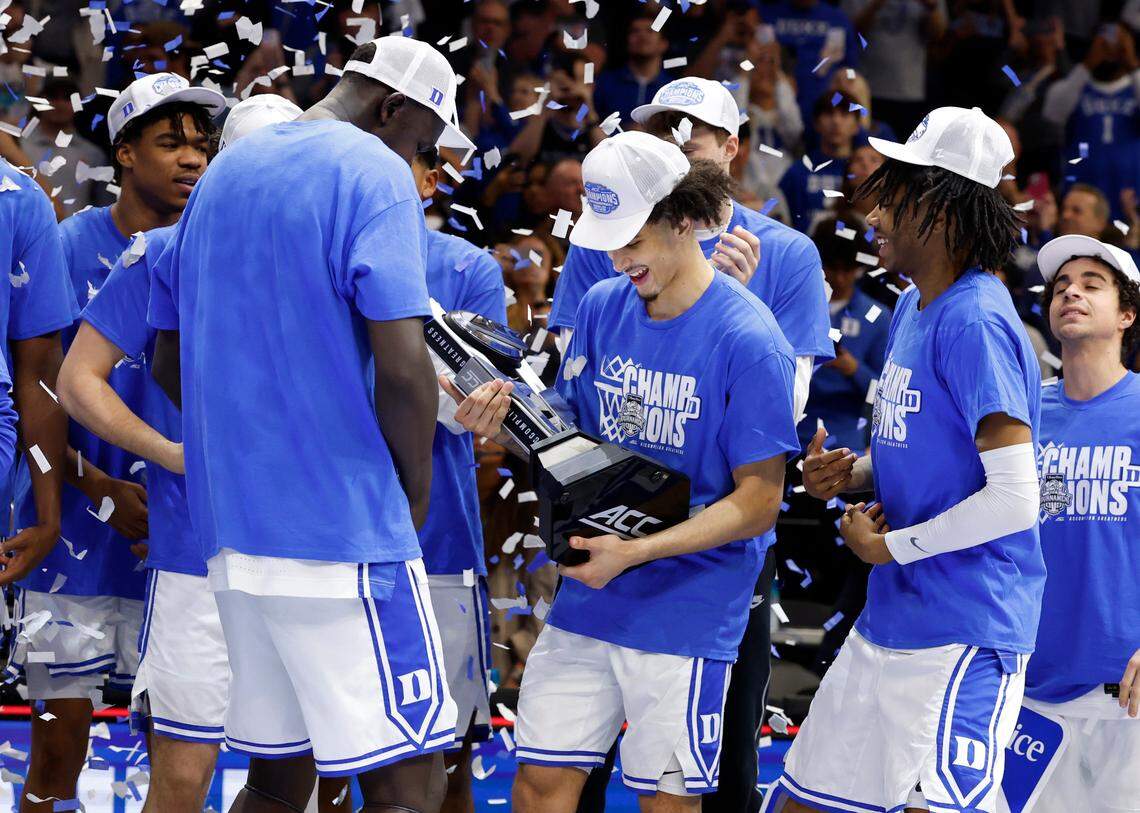 Duke’s Tyrese Proctor and the team celebrate with the trophy during the second half of Duke’s 73-62 victory over Louisville in the finals of the 2025 ACC Men’s Basketball Tournament at the Spectrum Center in Charlotte, N.C., Saturday, March 15, 2025.
