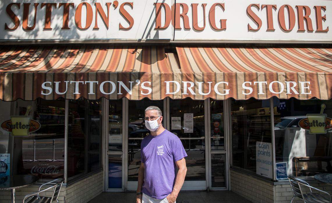 Sutton’s Drug Store owner Don Pinney stands for a portrait outside of the Chapel Hill, N.C. staple on Thursday, Aug. 27, 2020. The Franklin St. business has been serving the community and its visitors for 97 years. It has been negatively impacted by the coronavirus pandemic in multiple ways, as many local businesses have. Pinney, who has worked there for 42 years, hopes they can hold on and make it to 100 years in business.