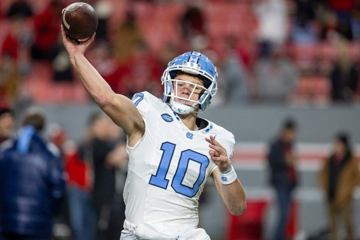 North Carolina quarterback Drake Maye (10) warms up for the Tar Heels game against N.C. State on Saturday, November 25, 2023 at Carter-Finley Stadium in Raleigh, N.C.