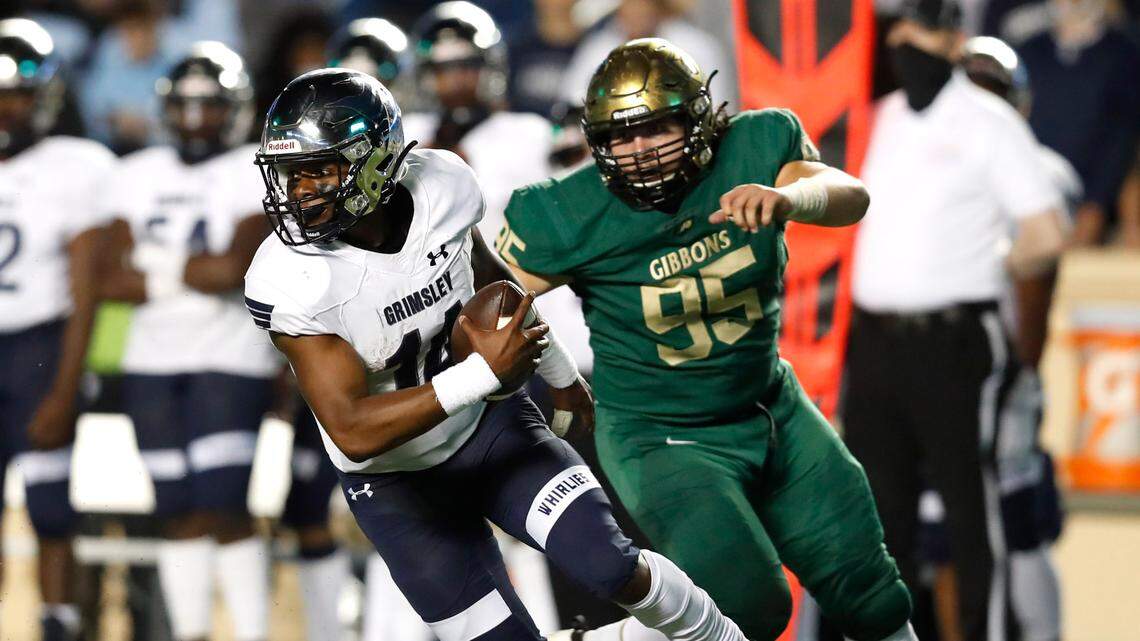 Grimsley’s Alonza Barnett iii (14) escapes from Cardinal Gibbons’ John Caramanico (95) during the second half of Grimsley High School’s 28-8 victory over Cardinal Gibbons High School in the NCHSAA 4A state championship game at Kenan Stadium in Chapel Hill, N.C., Friday, May 7, 2021.