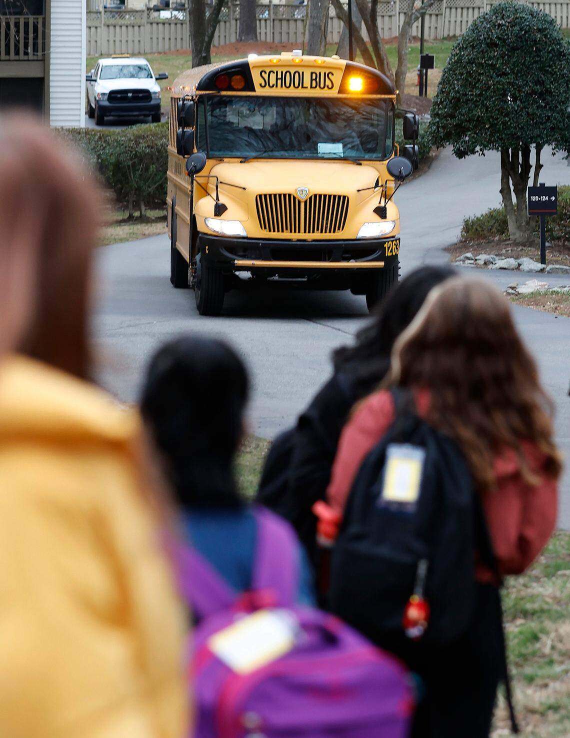 Students wait to board an approaching Wake County Schools bus earlier this year. Due to a driver shortage, Wake County will switch to an A/B schedule on 17 routes where middle school and high school students won’t get daily bus service.