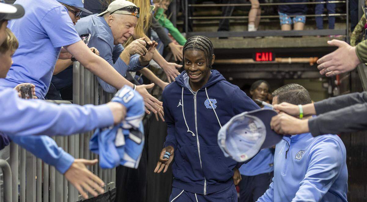 North Carolina forward Caleb Wilson, is greeted by fans as he leads the Tar Heels into Bon Secours Arena for their practice on Wednesday, March 18, 2026 in Greenville, S.C. North Carolina will face VCU in the opening round of the NCAA Tournament without Wilson, as he recovers from a broken thumb.