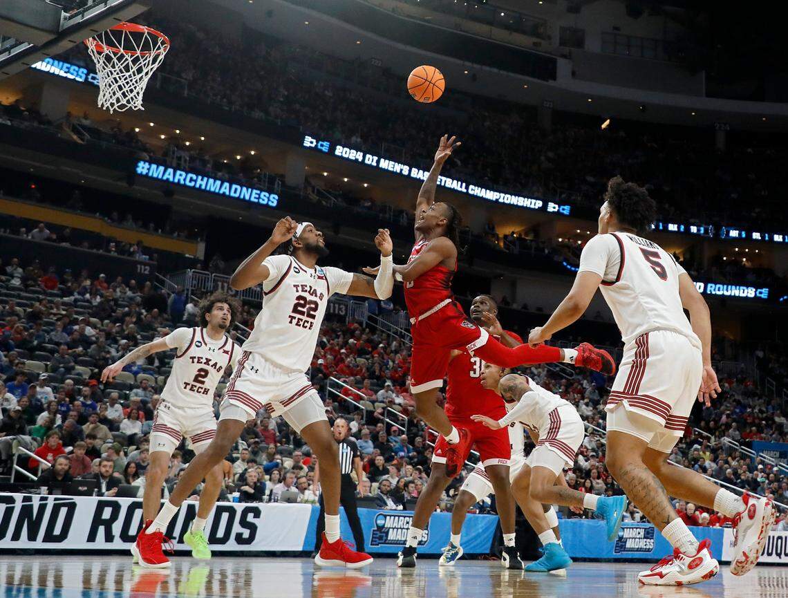 N.C. State’s DJ Horne puts up a shot over Texas Tech’s Warren Washington during the first half of the Wolfpack’s first round NCAA Tournament game on Thursday, March 21, 2024, at PPG Paints Arena in Pittsburgh, Pa.