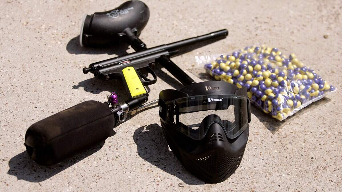 Gear used in paintball includes an air-powered gun and hopper, paintballs that are gelatin balls filled with paint and burst on contact, and a protective mask.