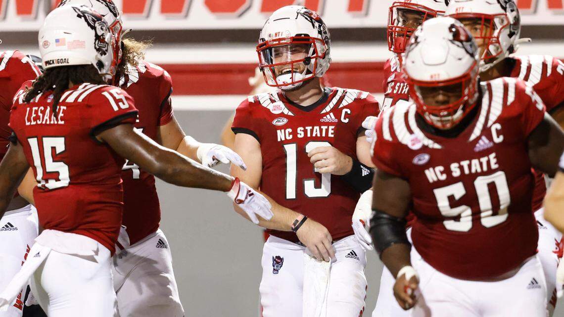N.C. State quarterback Devin Leary (13) celebrates with teammates after scoring on a seven-yard run during the Wolfpack’s game against Furman at Carter-Finley Stadium in Raleigh, N.C., Saturday, Sept 18, 2021.