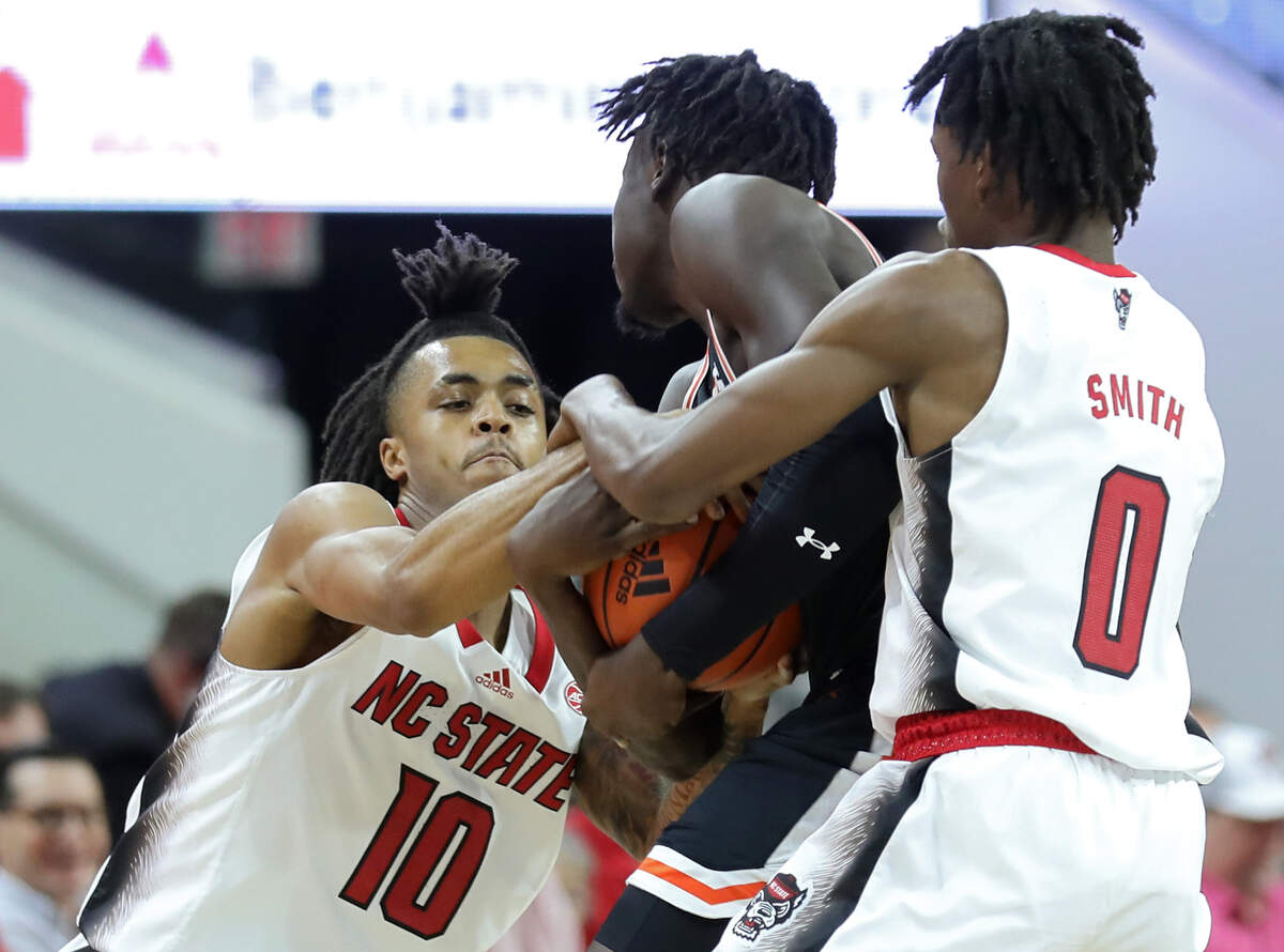 North Carolina State’s Breon Pass and Terquavion Smith closely defend Campbell Fighting Camels forward Jay Pal during the second half of a men’s basketball game at PNC Arena in Raleigh, N.C. on Friday, Nov. 11, 2022.