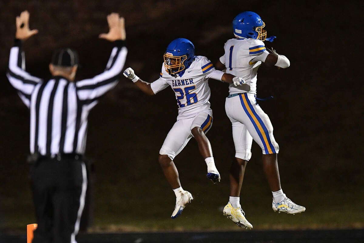 Garner's Aroson Randle (1) celebrates his touchdown against South Garner with running back Austin Williams (26). The South Garner Titans and the Garner Trojans met in a conference football game in Raleigh, N.C. October 17, 2025