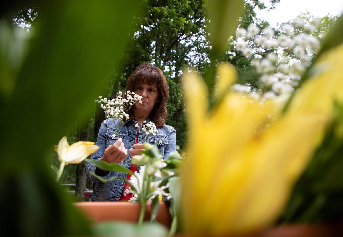 Kit Roberson adds stems of baby’s breath to a flower arrangement on Friday, May 6, 2022, in Cary, N.C. to be delivered to local recipients in honor of Mother’s Day.