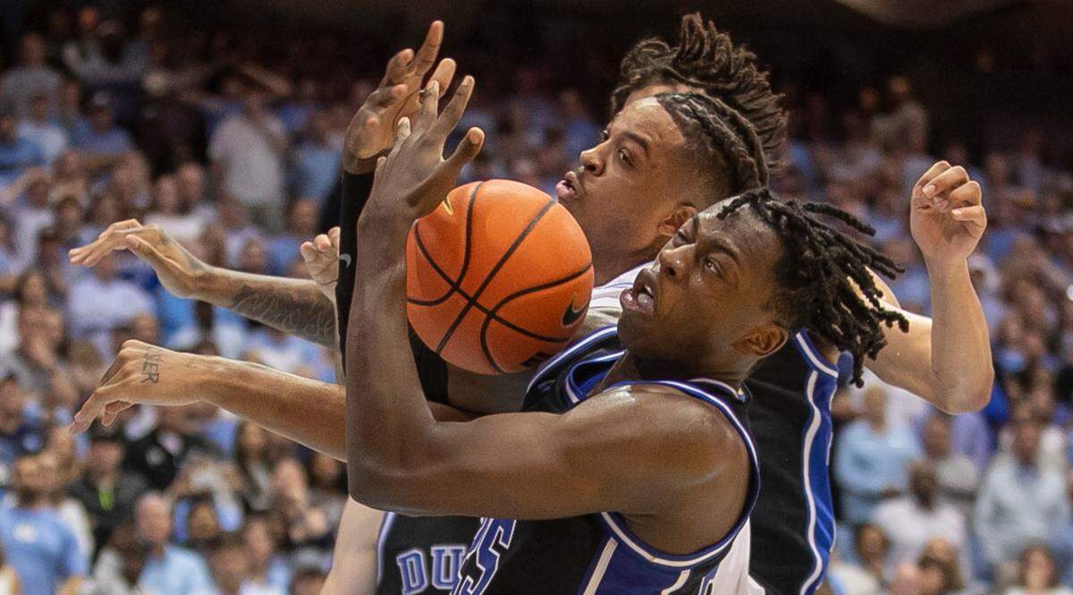 Duke’s Mark Mitchell (25) battles for a rebound with North Carolina’s Armando Bacot (5) in the second half on Saturday, March 4, 2023 at the Smith Center in Chapel Hill, N.C.