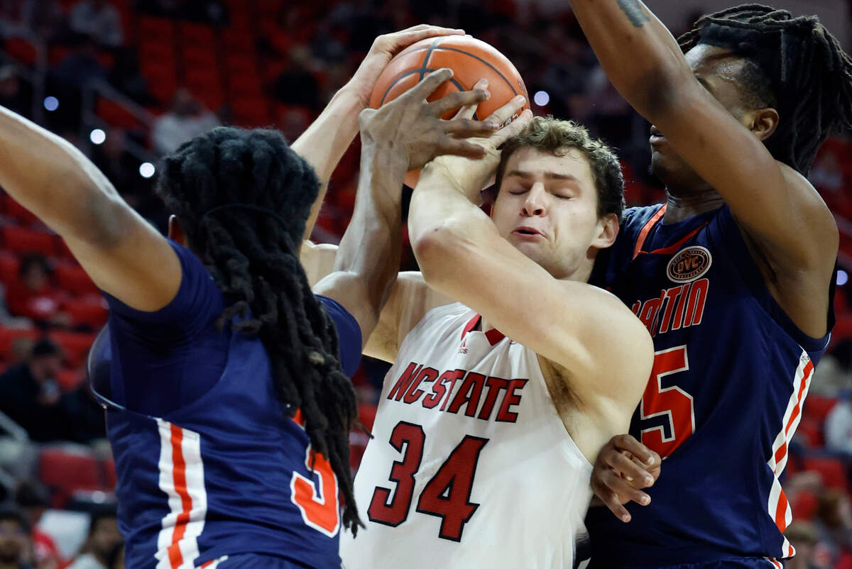 UT Martin’s Jordan Sears (3) and Christian Fussell (15) defend N.C. State’s Ben Middlebrooks (34) during the first half of N.C. State’s game against UT Martin at PNC Arena in Raleigh, N.C., Tuesday, Dec. 12, 2023.