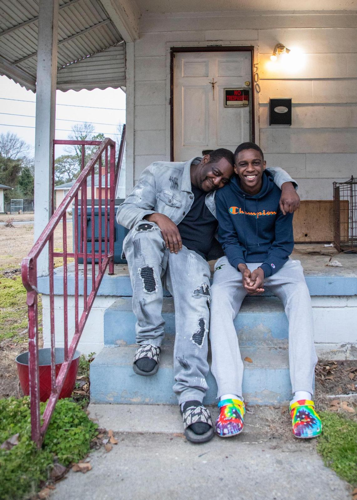 Adrian Canady and his son Jyrah, 17, a senior at Kinston High School who plays on the varsity basketball team, pose for a portrait together outside their home in Kinston, N.C. on Feb. 2, 2022.