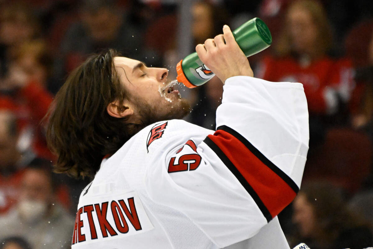 Carolina Hurricanes goaltender Pyotr Kochetkov (52) takes a drink before the first period of an NHL hockey game against the New Jersey Devils Saturday, April 23, 2022, in Newark, N.J. (AP Photo/Bill Kostroun)