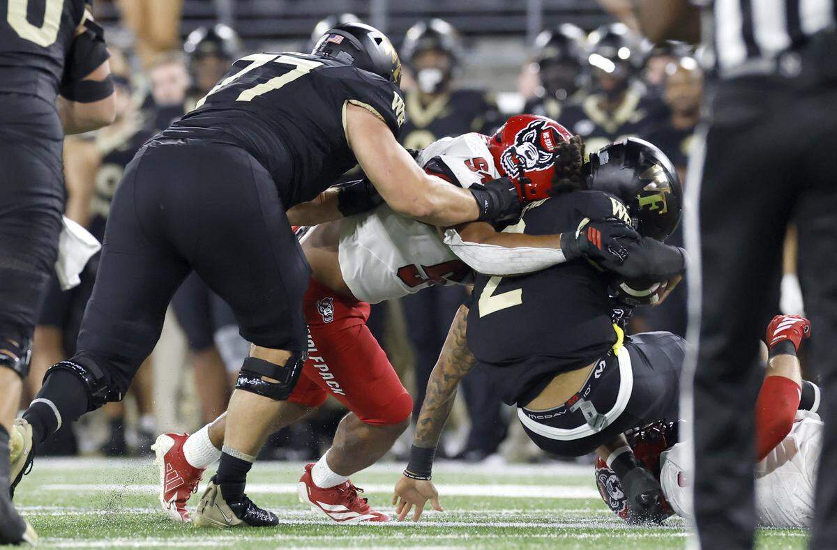 N.C. State defensive end Sabastian Harsh (54) hits Wake Forest quarterback Robby Ashford (2) while sacking him during the second half of N.C. State’s 34-24 victory over Wake Forest at Allegacy Stadium in Winston-Salem, N.C., Thursday, Sept. 11, 2025. Harsh was called for targeting on the play.