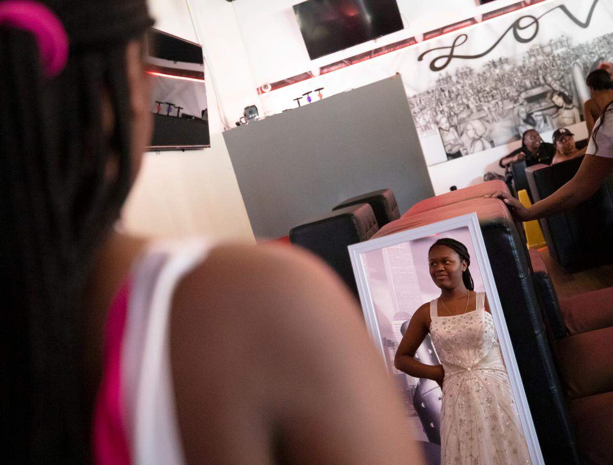 Isis Jarman, a junior at Southeast Raleigh High School, smiles as she tries on a dress during a prom dress drive held by the Hall Foundation at Jonathan’s Sports Lounge & Grill on Wednesday, April 20, 2022, in Raleigh, N.C.