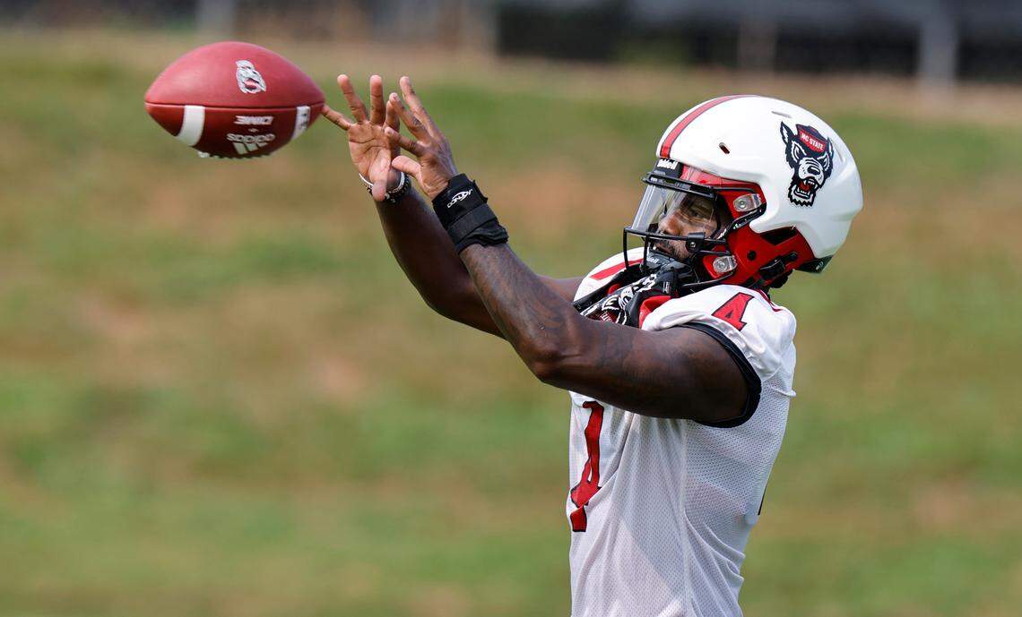 N.C. State wide receiver Porter Rooks (4) pulls in a pass during the Wolfpack’s first fall practice in Raleigh, N.C., Wednesday, August 2, 2023.
