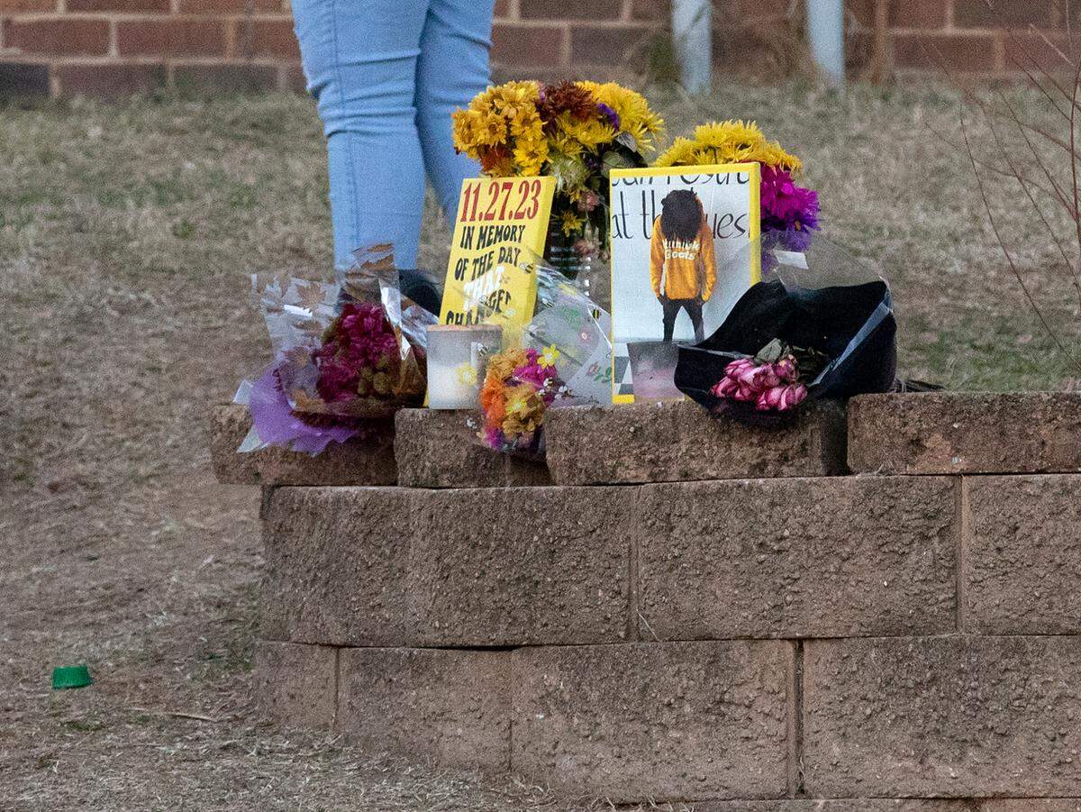 Flowers sit at a memorial prior to a balloon release to honor Delvin Ferrell on Wednesday, Nov. 29, 2023, in Raleigh, N.C. Ferrell, 15, died after being stabbed on Monday at Southeast Raleigh High School.