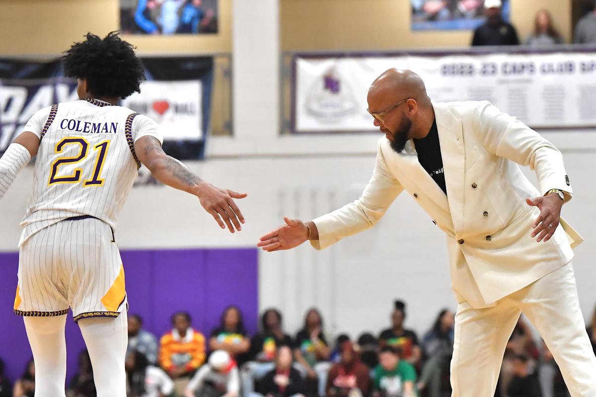 Word of God Head Coach Byron Williams congratulates Isaiah Coleman (21) after a play against Prolfic Prep. The Word of God Holy Rams and Prolific Prep (CA) met in the John Wall Holiday Invitational in Raleigh, N.C. on December 30,2022 .