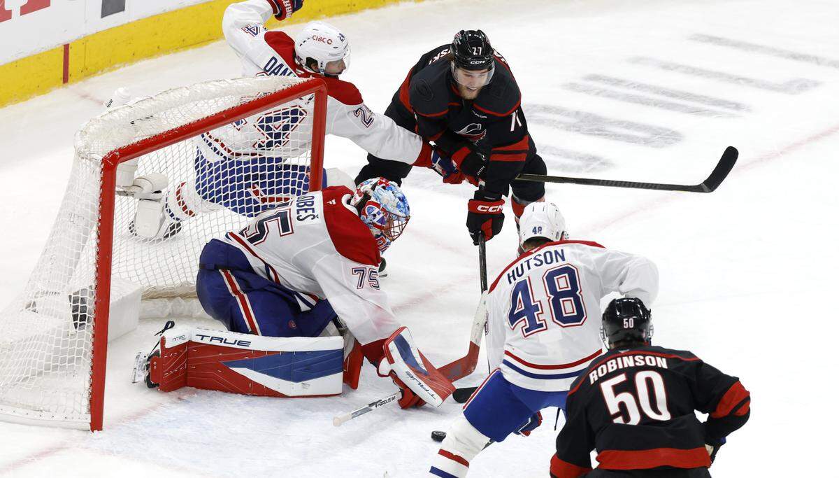 Carolina's Mark Jankowski (77) can’t get the puck in goal as Montréal's Jakub Dobes (75) defends in the third period of the Hurricanes’ game against the Canadiens in game two of the Eastern Conference Finals at the Lenovo Center in Raleigh, N.C., Saturday, May 23, 2026.