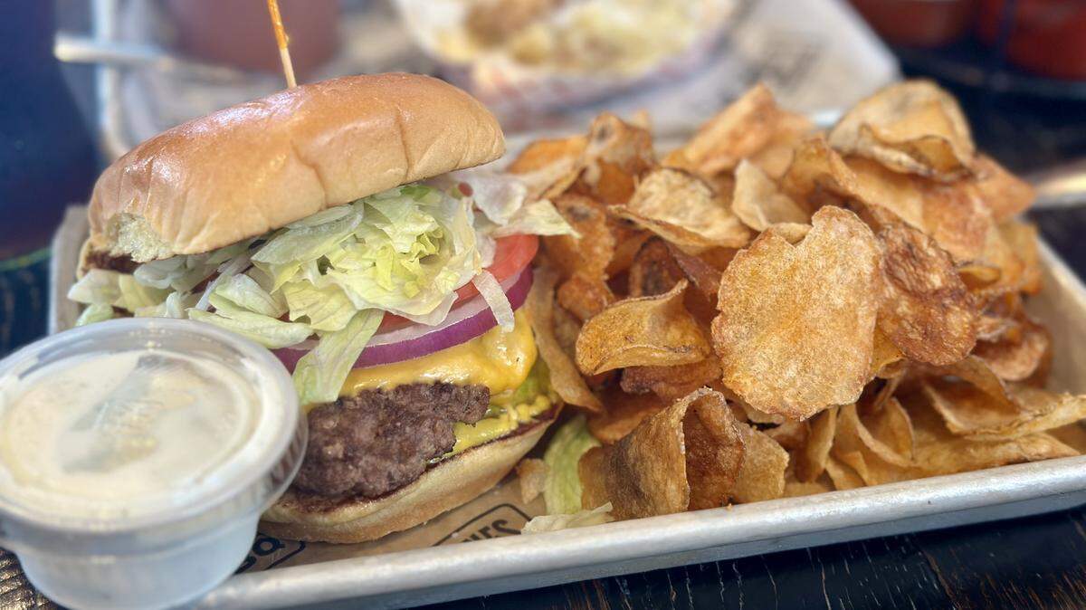 The 1947 burger made with American cheese, onion, tomato, lettuce, pickles, mustard and ketchup on a toasted bun.