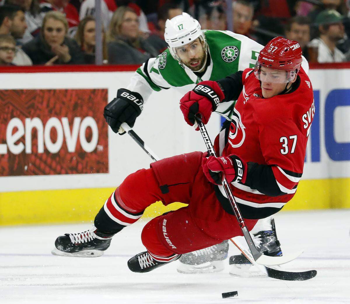 Carolina Hurricanes’ Andrei Svechnikov (37) trips over Dallas Stars’ Andrew Cogliano (17) during the first period of an NHL hockey game, Saturday, Feb. 16, 2019, in Raleigh, N.C. (AP Photo/Karl B DeBlaker)