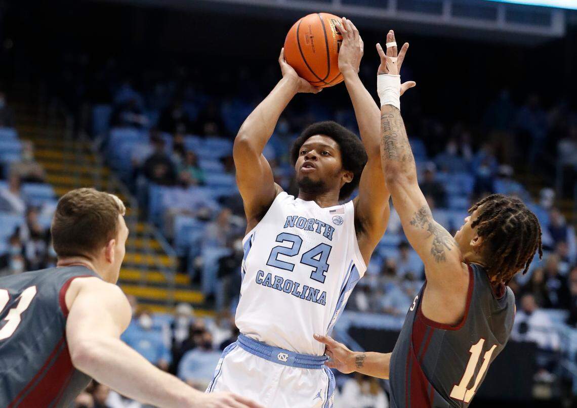 North Carolina’s Kerwin Walton (24) shoots as Boston College’s Makai Ashton-Langford (11) defends during the first half of UNC’s game against Boston College at the Smith Center in Chapel Hill, N.C., Wednesday, Jan. 26, 2022.